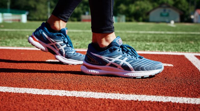 Männlicher Sprinter, welcher die ASICS Gel Nimbus auf der Laufbahn trägt
