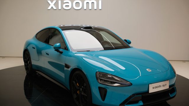 Shanghai,China-March 25th 2024: Xiaomi SU7 electric car with Xiaomi company brand logo sign