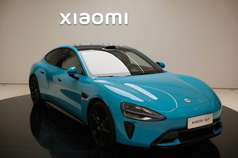 Shanghai,China-March 25th 2024: Xiaomi SU7 electric car with Xiaomi company brand logo sign