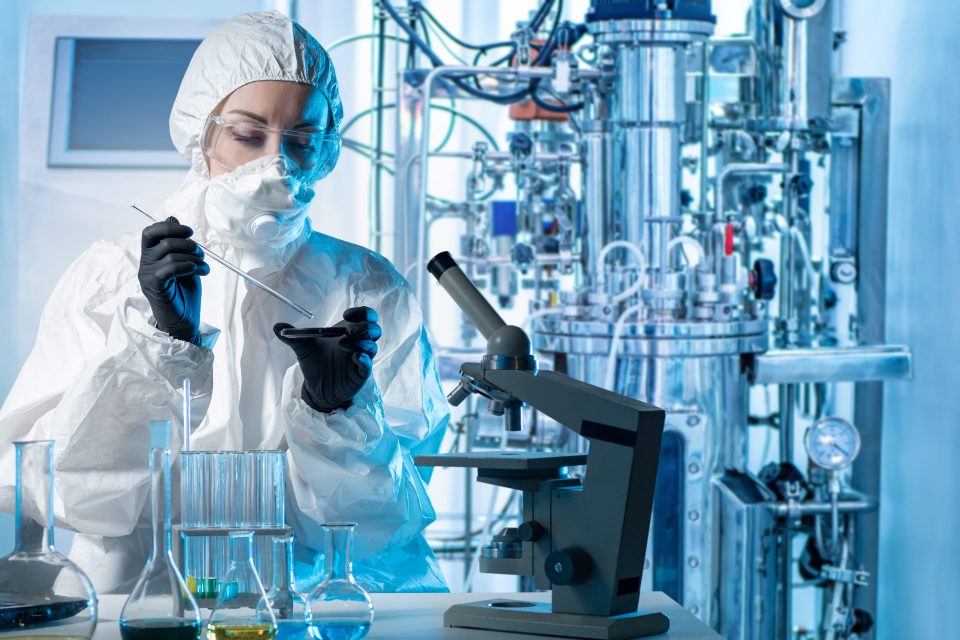 Laboratory assistant with microscope bio tech.